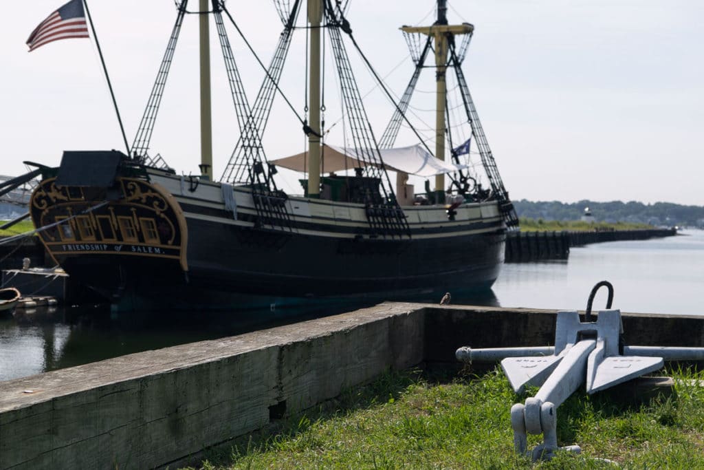 Colonial ship in Massachusetts bay with an anchor. 